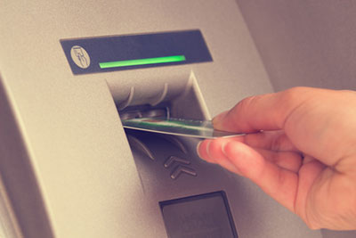 hand putting card into atm